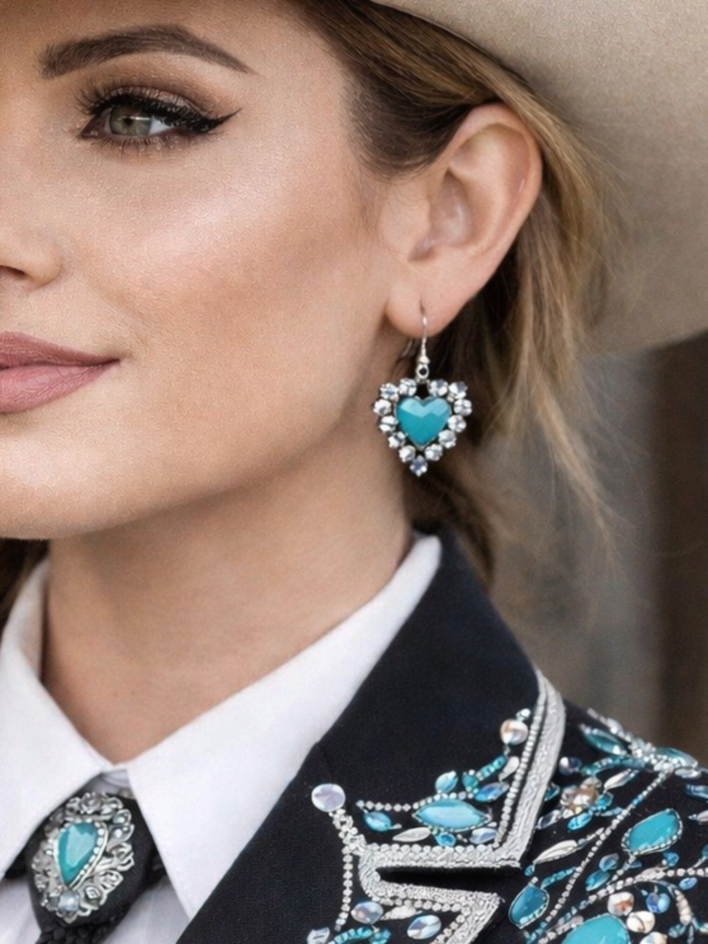 Heart Earrings. Teal blue heart in center. Gemstones all around.